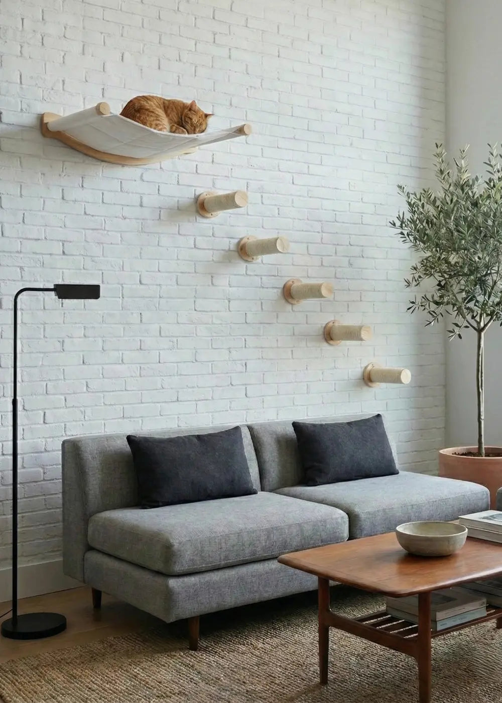 A ginger cat sleeping peacefully high up in the Purrfait Skyline wall-mounted hammock, demonstrating the cozy resting spot provided at the top of this vertical climbing route.