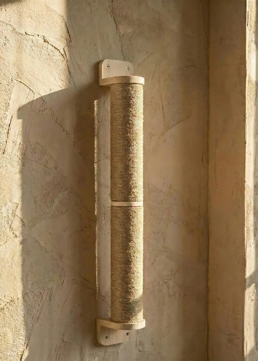 The Purrfait Axis, a minimalist wall-mounted cat scratcher in natural wood and sisal, designed to provide vertical scratching space without taking up floor area.