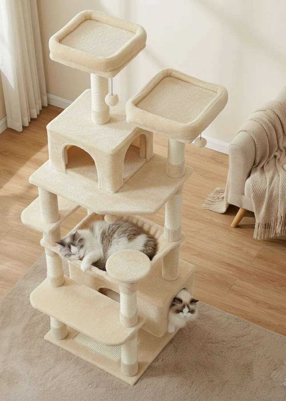 High-angle view of the Purrfait Citadel large cat tower in beige, featuring multiple levels, two condos, and a cozy hammock occupied by sleeping Ragdoll cats in a bright, modern room.