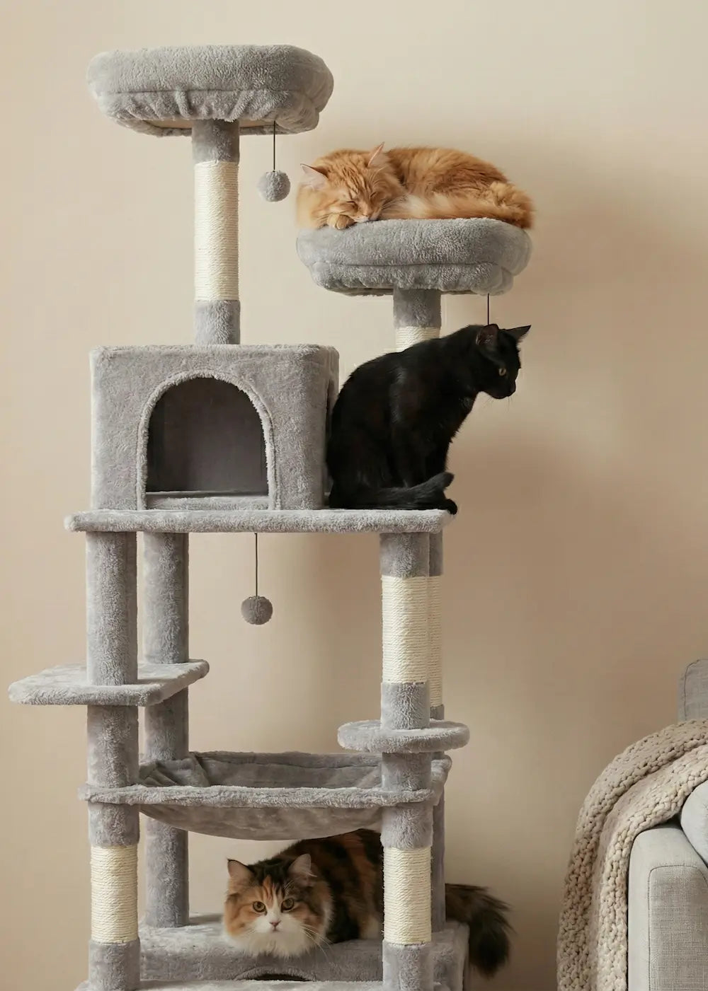 Three cats enjoying the Purrfait Citadel multi-cat tower, with an orange cat on the penthouse perch, a black cat on the middle platform, and a calico resting below.