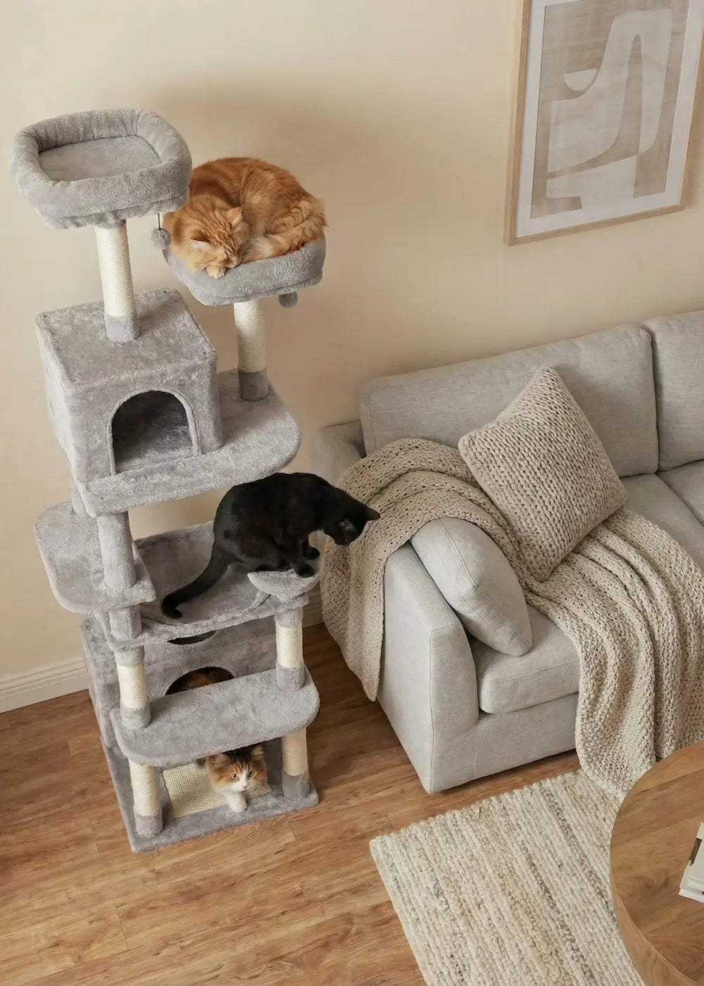 A tall Purrfait aesthetic cat tree in a living room setting, showcasing its capacity for multiple cats to climb, sleep, and play simultaneously on soft grey plush.