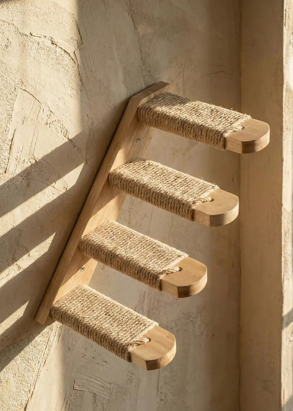 Purrfait Tier, a set of wall-mounted cat steps featuring four durable sisal-wrapped wooden treads, installed on a textured wall to create a vertical climbing path.